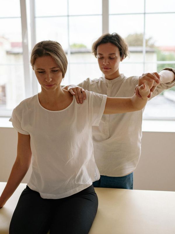 Person doing gentle stretching movements in a calm dark room